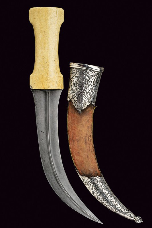 Kandshar (dagger): dating: 19th Century provenance: Persia Fine, curved, double-edged blade of fine damask, with fuller at the center; walrus-ivory grip with hollow sides; wooden scabbard with brown, velvet (worn) cover