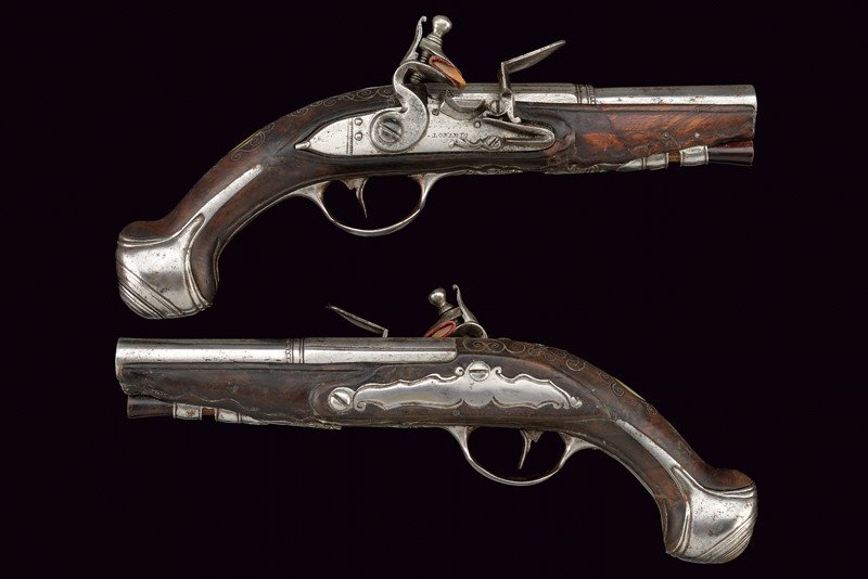 A travel flintlock pistol signed P. Lorandi: dating: 18th Century provenance: Northern Italy Smooth, two-stage, octagonal, 13 mm cal. barrels with longitudinal and round grooves, featuring rings and a frame at the girdle. Flintlock with flat pla