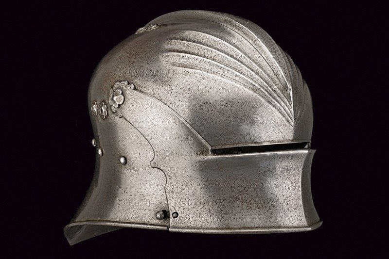 An extremely rare sallet from the famous Kuppelmayr: dating: last quarter of the 15th Century provenance: Germany Hammered skull in one piece, featuring a large and short comb at the top, with outlined borders and base; engraved with flowers at the base