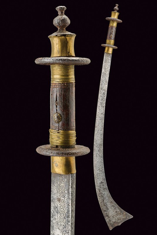 A kora, dating: 19th Century, provenance: Nepal,: A kora, dating: 19th Century, provenance: Nepal, dating: 19th Century, provenance: Nepal, Curved, single-edged blade with widened and undulated tip; engraved at the base and at the back, areas with da