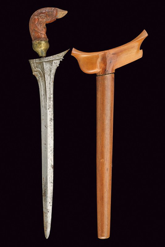 A kris, dating: circa 1900, provenance: Indonesia,: A kris, dating: circa 1900, provenance: Indonesia, dating: circa 1900, provenance: Indonesia, Straight, double-edged blade with grooves and carvings at the base; wooden grip, sculpted in the kingfishe