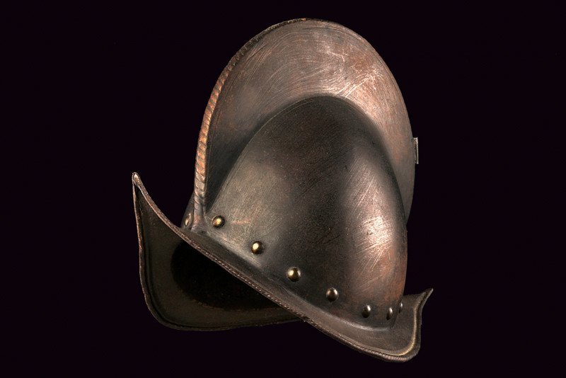 A morion, dating: circa 1600, provenance: Italy,: A morion, dating: circa 1600, provenance: Italy, dating: circa 1600, provenance: Italy, Skull in one piece with medium-high crest and tested border, brim with grooved edge and hemmed border, row of ri