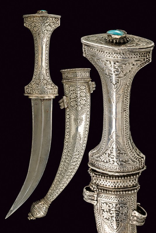 A silver mounted jambiya, dating: early 19th Century,: A silver mounted jambiya, dating: early 19th Century, provenance: Arabia, dating: early 19th Century, provenance: Arabia, Curved, double-edged blade with raiser at the center and damask structure; sil