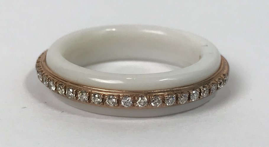 10k white coral & dia Donna Karan ring, 2.4 dwts: 10k white coral & dia Donna Karan ring, 2.4 dwts.This ring contains 35 round .02ct diamonds, SI1 and H color for a total diamond weight of .70cts.Marked:"10k DKNY China". Ring size:6.5
