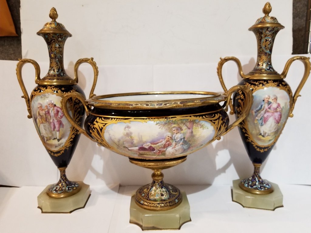 Sevres type 3 piece cobalt garniture set, c.1900: Sevres type 3 piece cobalt garniture set, c.1900. Covered vases: 6"x 14.5" each. Oval centerpiece: 12"x 8.25".All three pieces are stamped "France" on the bottom.