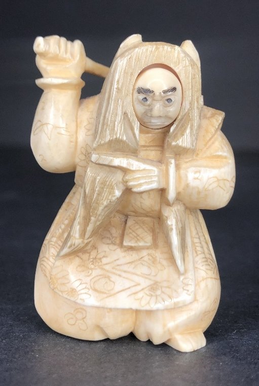 Japanese bone netsuke of Hikoshichi witch, face turn: Japananese bone netsuke of Hikoshichi witch, face turns. Signed. 2 1/4" high (From the woodblockprints.org site):Omori Hikoshichi (lived about 1340), a vassal of Shogun Ashikaga Takaugi (1305-58), off