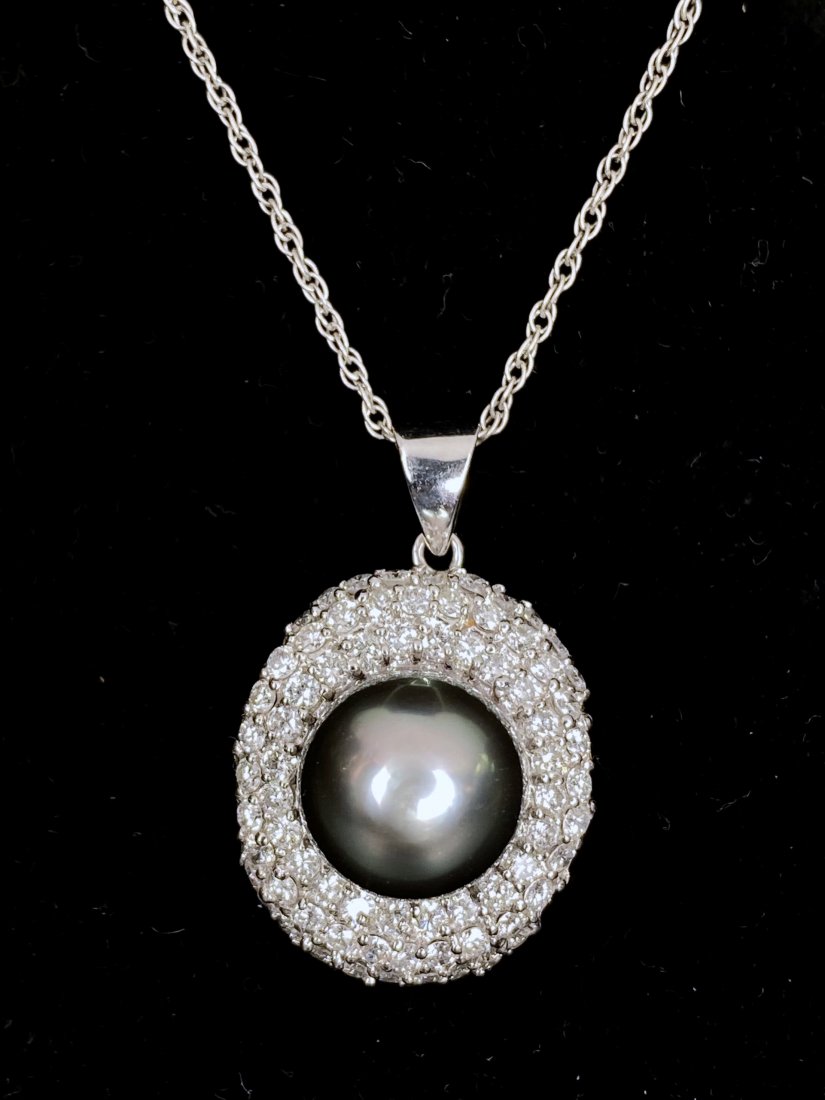 14k diamond and Tahiti black pearl necklace, 6.7dwt: 14k diamond and Tahiti black pearl necklace. 6.70 dwt, length:16 inches. Davids notes: The black Tahitian pearl is 11.24mm.There are numerous rows of diamonds around the pearl, totaling approximately 