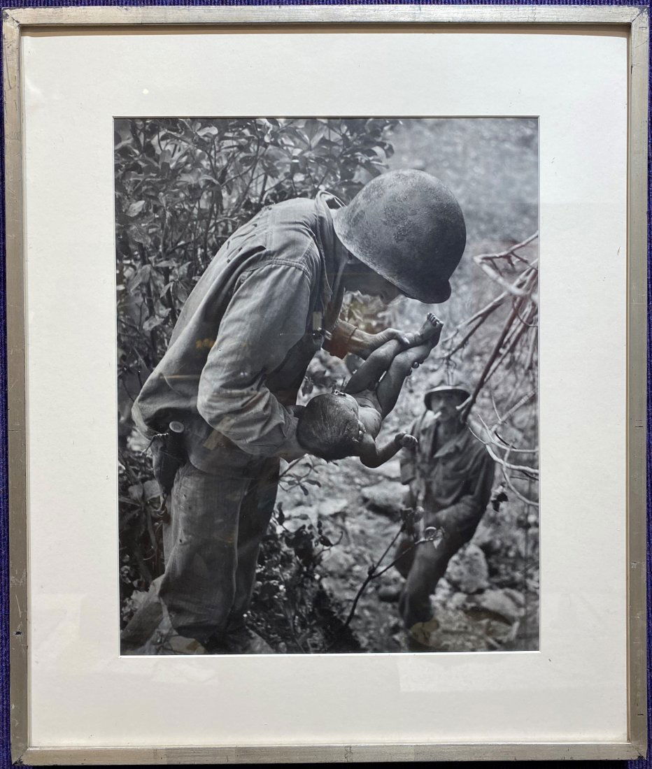 W. Eugene Smith photo, Marine & Infant, stamped: W. Eugene Smith photo, Dying Infant Found by American Soldiers in Saipan, June 1944, stamped Photo: 13 1/2" x 17 1/2" Frame: 20 1/2" x 24 1/2" (Source: unveiled.corcoran.gwu.edu) In this photograph, U