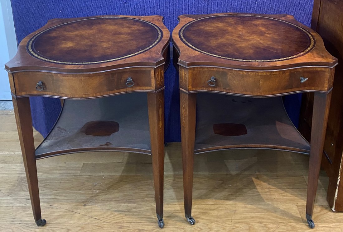 Pair of mahogany side tables on casters: Pair of mahogany side tables on casters Tables are 27" high and top is 22" across at the widest point