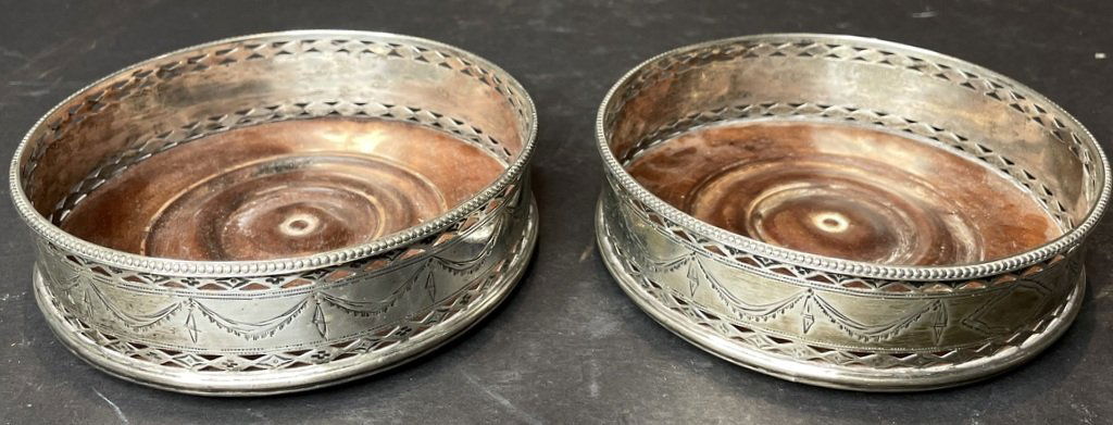 Pair of Georgian sterling silver wine coasters, 1815: Pair of Georgian sterling silver wine coasters, 1815 Height: 1.25 inches, diameter: 4.75 inches.Davids notes: the leopards head is crowned, the date letter is U, the Georgian profile is there and the