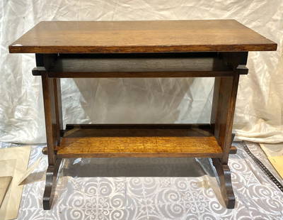 The Roycrofters bench, c1910: The Roycrofters bench, c191026"L x 14"W x 19.5"HSeveral of the wood triangle stops that fit in the slots that prevent a section of wood from being pulled out are missing.The Roycrofters(source: