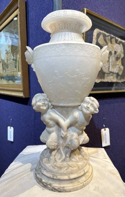 Alabaster lamp with fauns around Neoclassical vase: Alabaster lamp with fauns around Neoclassical vase 21 inches x 10 inches x 8 inch diameter base.Insription inside, difficult to read but appears to include the word Italy.Might say Made in Italy.