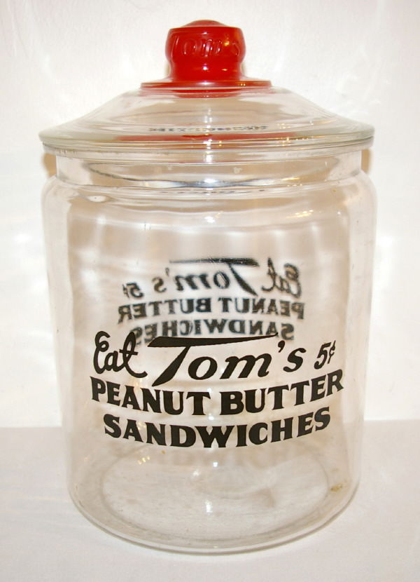 Tom's General Store Glass Jar: "Eat Tom's Peanut Butter Sandwiches" General Store Glass Jar. Measures 9" in Diameter and 13.5" Tall.