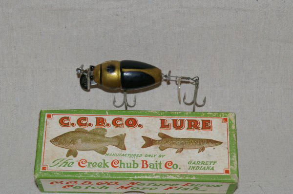 Creek Chub Baby Beetle Fishing Lure In Box: Creek Chub Black And Gold Baby Beetle Lure. Length 2.75". In Original Box. qty: 1
