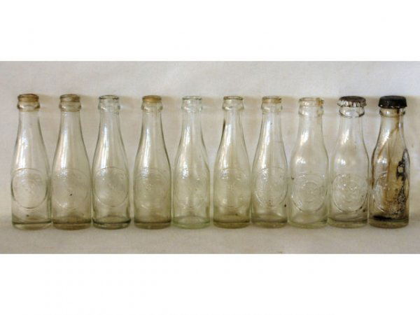 10 Vintage Miniature Dr Pepper Bottles: Diana's Collection of 10 1940s Miniature Dr Pepper Bottles & Case. All bottles read (in raised letters): "Dr Pepper, Good for Life" and the 10-2-4 Clock Face. Six matching bottles have a bottom mark o