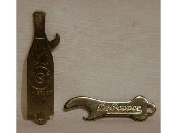 Two Early Dr Pepper Advertising Bottle Openers: Two Vintage Dr Pepper Bottle Openers. One reads: "Dr. Pepper" and measures 2-3/4" long; and the other reads: "Dr Pepper, Good For Life, 6-1/2 Ozs. and "Drink A Bite To Eat at 10 - 2 - 4" on the revers