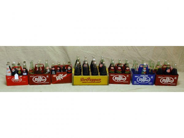 49 Commemorative Dr Pepper 32oz & 16oz Bottles: 49 Commemorative Dr Pepper 32oz & 16oz Bottles. Includes Wooden Crate (Has King of Beverages on inside board), Plastic & Cardboard Carriers. Bottles Include: 1975 Arkansas State University, 1980 & 198