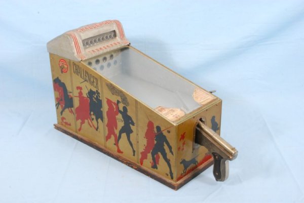 Challenger Coin Op Shooting Arcade Game: Challenger Shooting Game. Has paper label 10 Shots for 1 Cent" intact. Measures 9-1/4" W x 23" D x 15" H. Paper inspection tag dated 1941."