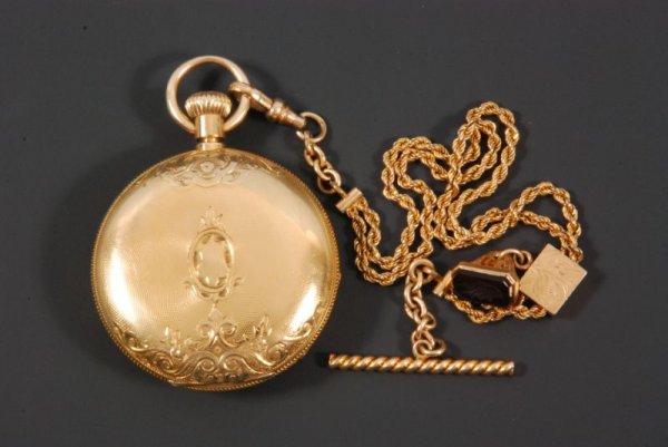 Elgin Keywind 18kt Gold Pocket Watch With Chain: Watch marked 18kt with Crown. National Watch Company. Elgin works serial #128739. "R W Raymond Serial #18698" engraved inside works. With Simmons Gold Slide Chain stamped "Simmons". 141 grams gross we