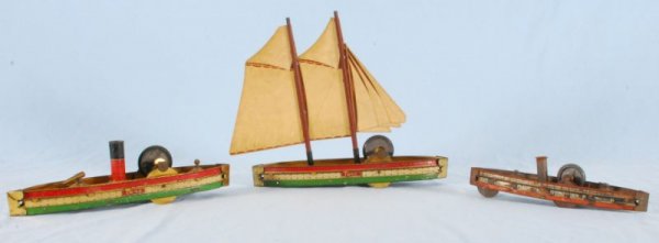 Collection of Hill Climber Toy Sailboats: Tin Sailboat Hill Climber Toy, 1045 on side. "Pennsylvania", & "C.F. Foy Captain" scratched in on both sides also. (12" L x 3" W x 10-1/2" H) (P978.101.366); Hill Climber Tin Toy Boat. (9-1/2" L x 2" 
