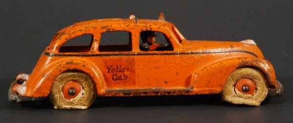 Hubley Yellow Cab with Driver: Cast Iron. Measures 7-3/4" L x 3" W x 2-3/4" H. (P978.101.665)