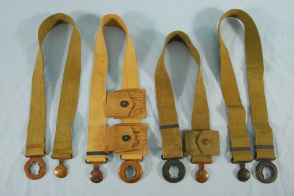 Collection of 4 US Cavalry Garrison Belts: Includes: 3 US Model 1910 belts. One dated 1917 with two Model 1910 cartridge punches on the belt; One stamped "Mills" and one with single cartridge pouch with a rimmed eagle snap. Inside surface of t