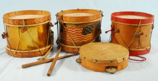 3 Antique Toy Drums & Tombourine: Includes 3 toy drums, drumsticks (1 stick is also a whistle) and tambourine (underside inscribed "Vera Busse Oct 28-29-30-1909 Carnival of Nations"). Drums measure 8" D x 7" H. (1990.64.02 HCHS; 978.1