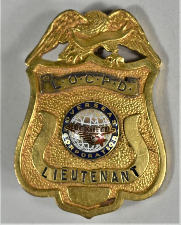 Lockheed Overseas Police Department Badge: Lockheed Overseas Corporation Police Department Lieutenant Badge. Gold with enamel emblem is anchored with screw and washer. 1 1/2 X 1 1/2 inches.