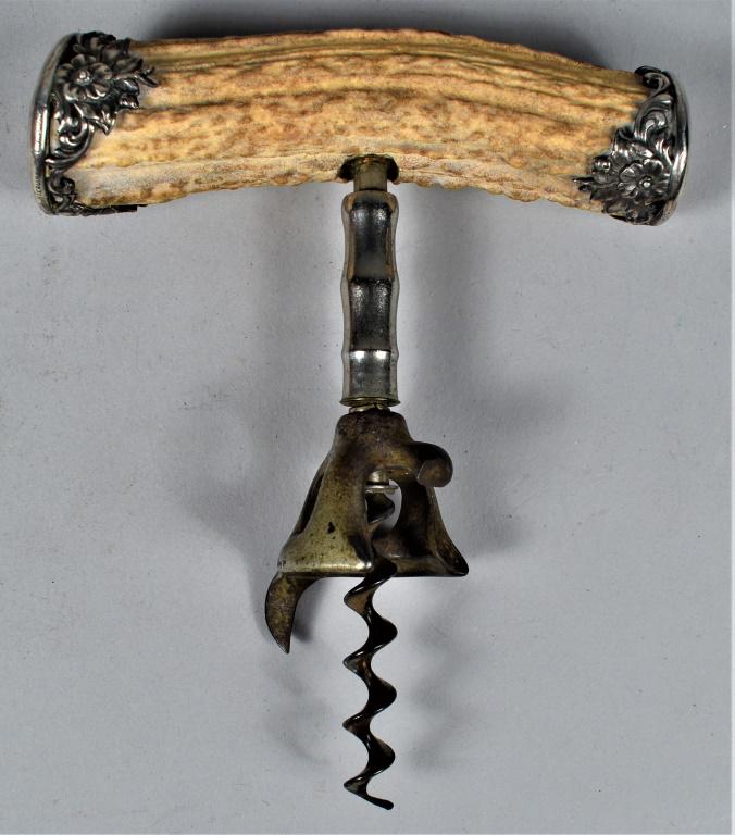 Sterling Silver and Stag Handle Cork Screw: Sterling Silver and Stag Handle Cork Screw. High relief floral dÃ©cor caps with hallmark (lion/anchor/G ), sterling B 1738. 4 1/2 inches across.