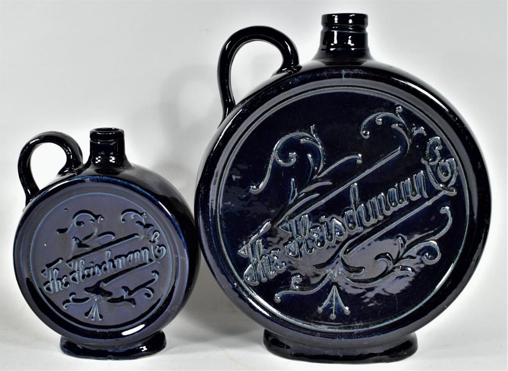 Fleischmann Co. Distilling Whiskey Bottle Jug: The Fleischmann Co. Distilling Stoneware Canteen Whiskey Bottle Antique Pottery Jug. Cobalt blue in two sizes. No chips or cracks. 1 and 1/2 gallon jugs measure 12 1/4 X 8 1/2 inches tall.