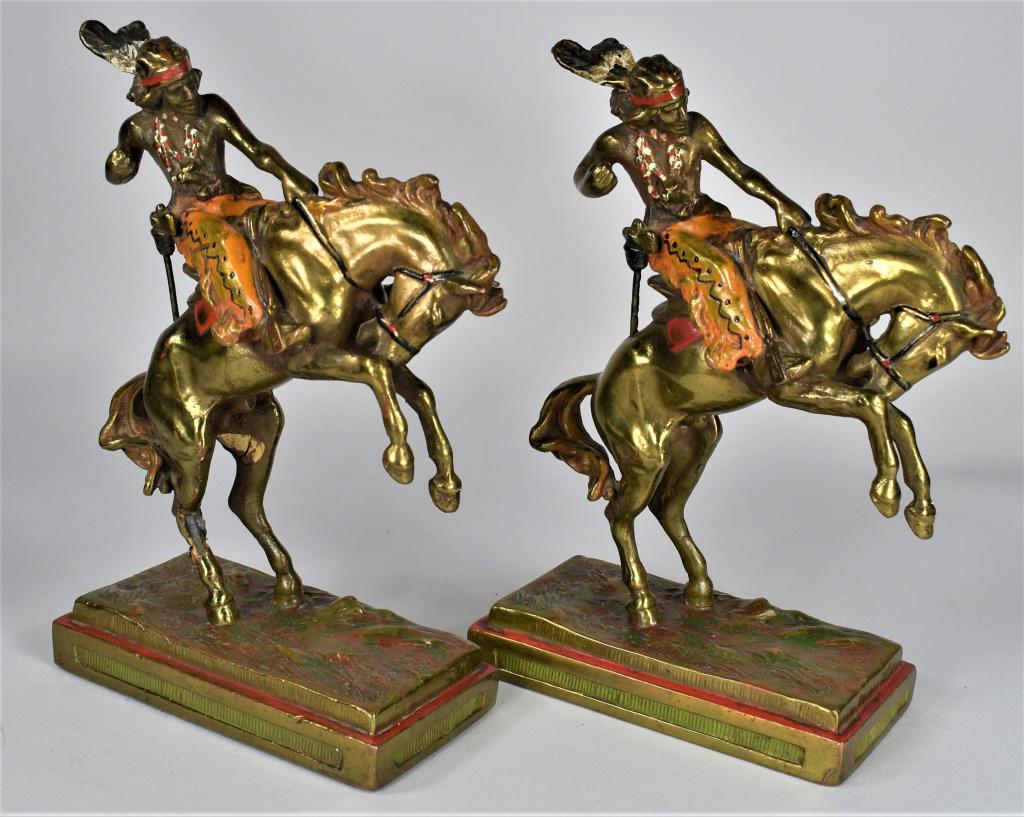 Armor Bronze Indian Brave Bookends: Armor Bronze Native American Indian Brave Bookends. Ca. 1920's polychrome painted. Leg on one horse has been repaired and has chip on interior of his thigh at repair. This pair still presents very wel