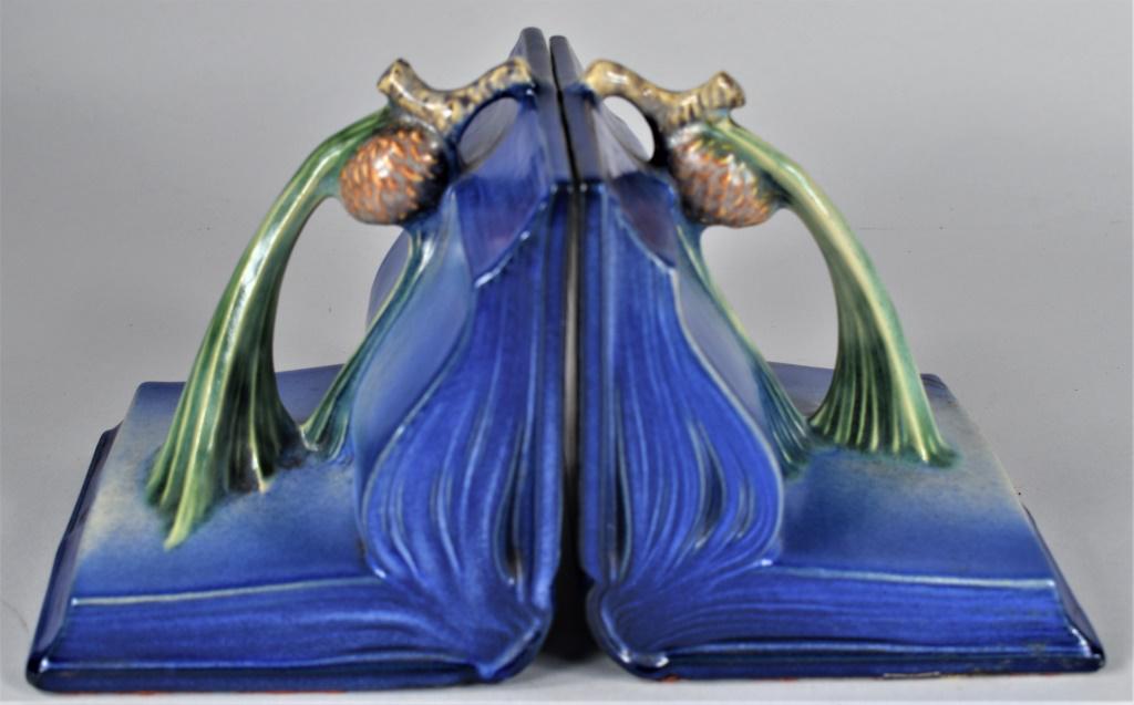 Roseville Blue Acorn Pattern Bookends: Roseville Blue Acorn Pattern Bookends. One end has a repaired crack on outer edge, they still display very well. Each end measures 4 3/4 X 5 X 5 1/4 inches.