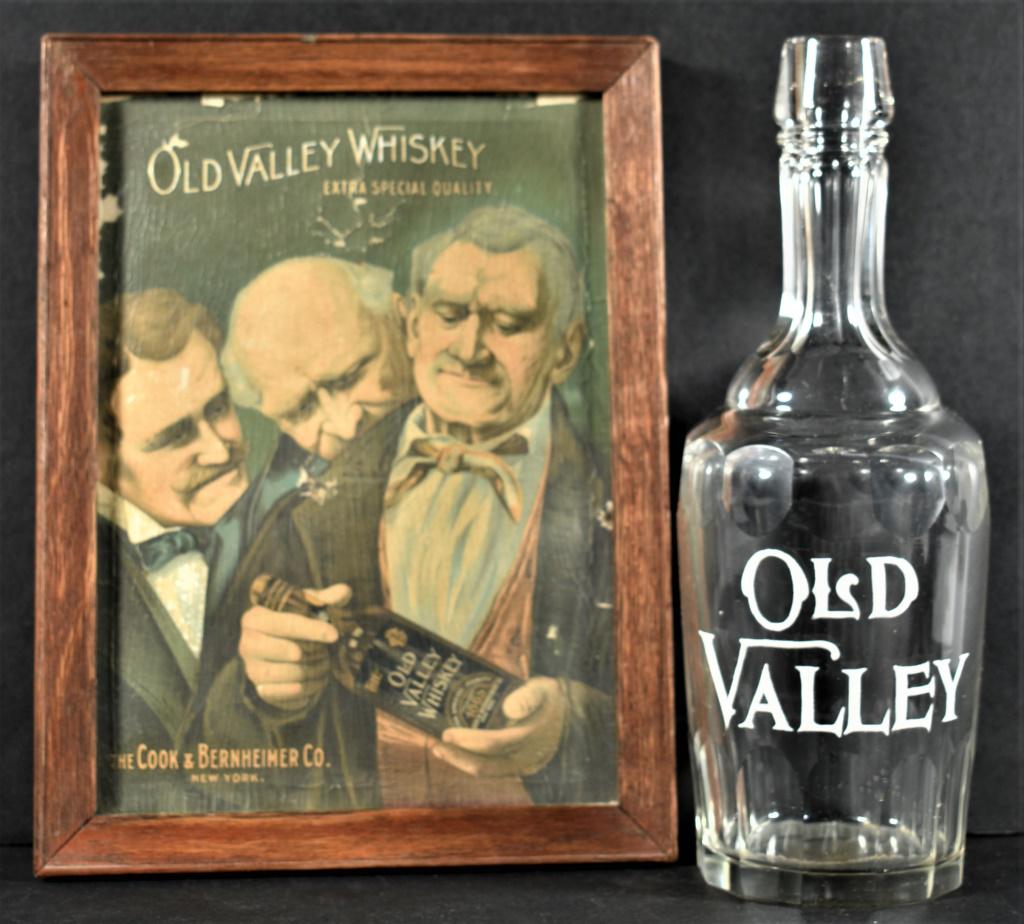 Enamel Label Decanter for Old Valley Whiskey with Advertising Sign: Enamel Label Decanter for Old Valley Whiskey with Advertising Sign. Bottle has no chips or cracks and measures 10 inches tall. Old Valley Whiskey sign, The Cook & Bernheimer Co. Age crazing with some