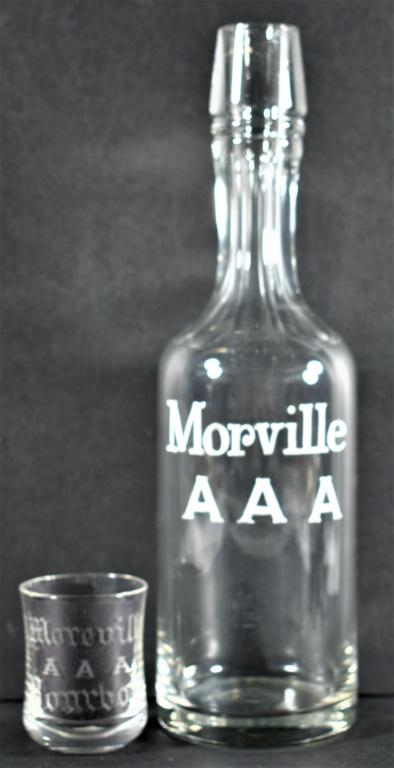 Enamel Label Back Bar Bottle for Morville AAA Bourbon: Enamel Label Back Bar Bottle for Morville AAA Bourbon and etched shot glass. Bottle measures 11 1/4 inches, shot glass has one lip chip.