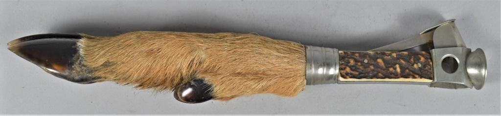 Tobacciana Deer Foot/Hoof Handle Cigar Tip Cutter: Tobacciana Deer Foot/Hoof Handle Cigar Tip Cutter. The nickel plated cutter is attached to a 1 3/4 inch stag handle with nickel collar above hoof/foot. Some hair loss on one side. 8 1/2 inches overall