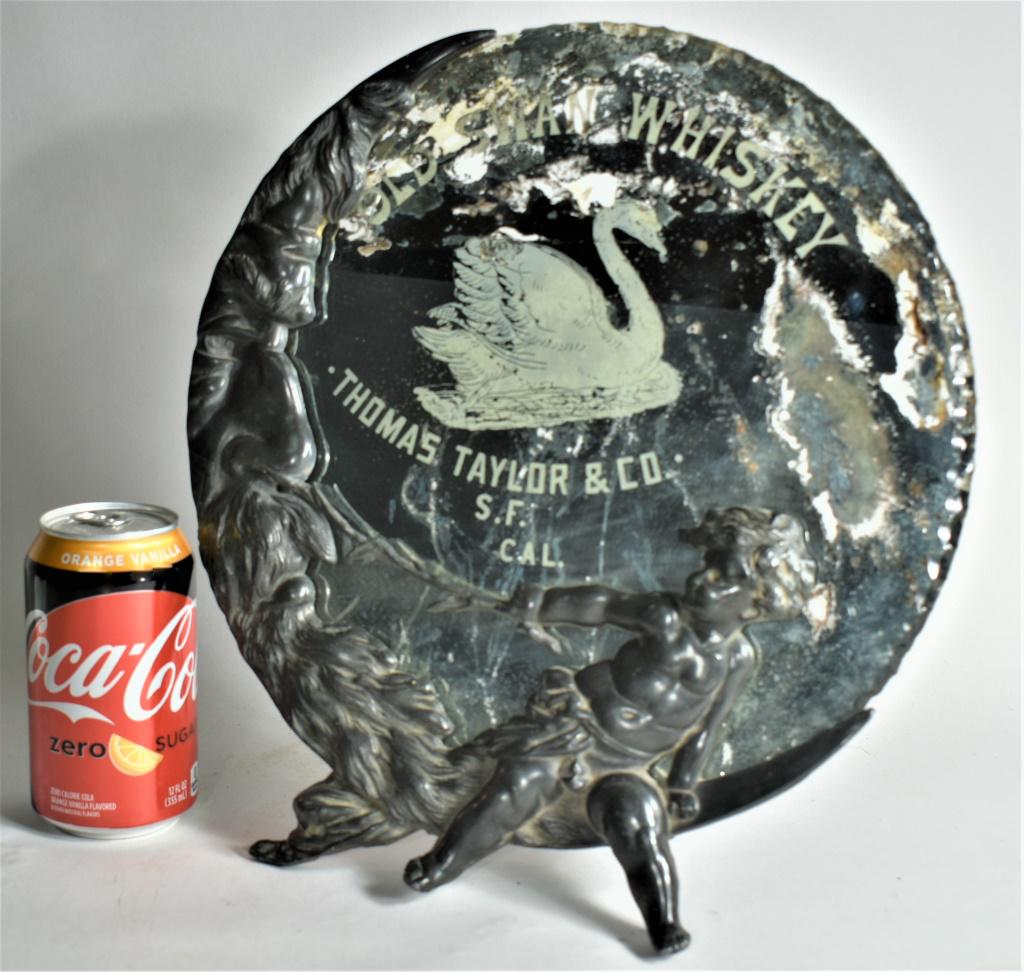 Advertising Mirror for Old Swan Whiskey: Advertising Mirror for Old Swan Whiskey. Thomas Taylor & Co. San Francisco, Cal. Reverse glass advertising on round beveled edge mirror, significant silver loss. Sits in ornate white metal easel back 