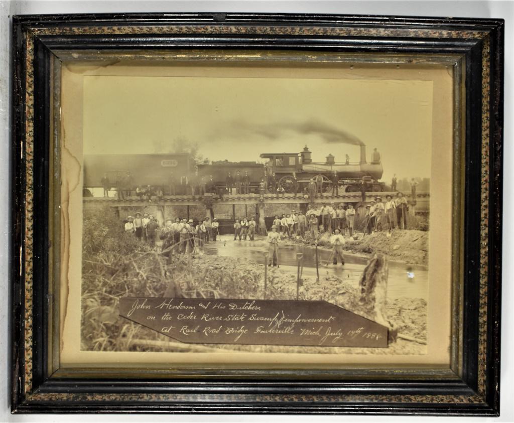 Railroad Bridge Photo from Fowlerville, Mich: Railroad Bridge Photo from Fowlerville, Mich. John Henderson and His Ditchers on the Cedar River State Swamp land improvement at Rail Road Bridge Fowlerville, Mich July 19, 1886. Framed under glass. 1