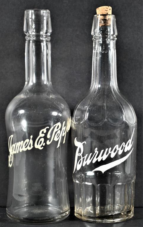 Enamel Label Back Bar Bottles for James E. Pepper and Burwood Whiskey: Enamel Label Back Bar Bottles for James E. Pepper and Burwood Whiskey. Scratch crack at top of Pepper bottle. 11 1/4 inches tall.