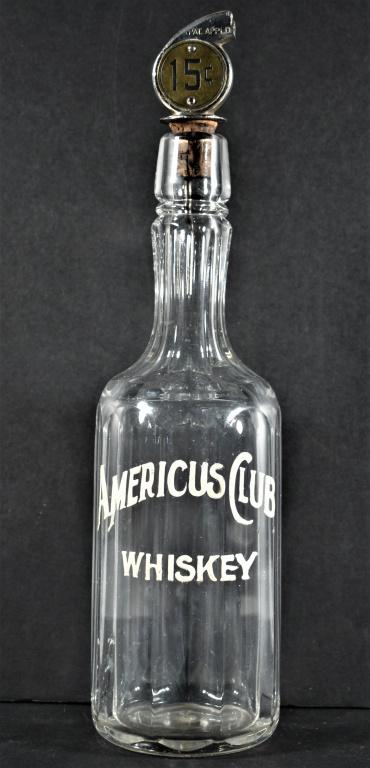 Enamel Label Back Bar Bottles for Americus Club Whiskey: Enamel Label Back Bar Bottles for Americus Club Whiskey. Small chip on front column edge otherwise overall good condition. Comes with 15 cent shot stopper. 11 1/4 inches tall.