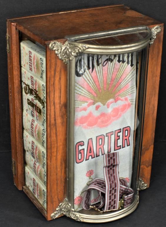 Sun Garter Store Display Case: Sun Garter Store Display Case. Original oak, curved glass front and sides with nickel ornate trim. 7 1/2 X 11 X 7 inches.