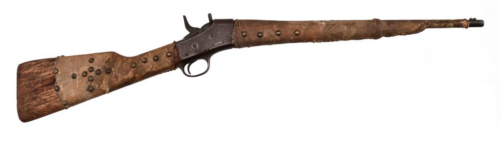Remington Falling Block Carbine Indian Tack: S/N 414. Remington Falling Block carbine wrapped in rawhide with brass tacks throughout, .30 caliber, 20.5" round barrel. Heavy wear is noticeable on metal and wooden pieces that are not wrapped in th