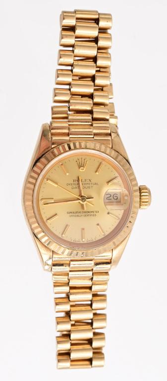 Rolex Ladies Oyster Perpetual DateJust 18K Watch: With appraisal: "One 18kt. yellow gold, ladies, Oyster Perpetual Datejust wrist watch. The case features a 26.0mm champagne dial with a fluted bezel and sapphire crystal complete with a cyclops lens o