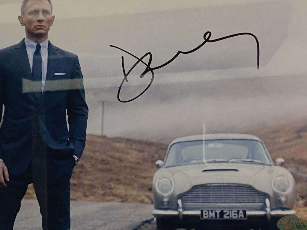 Skyfall James Bond Signed Movie Photo: Skyfall James Bond signed movie photo autographed by Daniel Craig. Custom matted and frames. Measures 17x18 inches