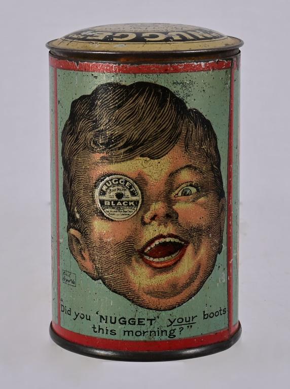 Nugget Boot Polish Coin Bank Tin: This coin bank was made to promote "Nugget" shoe polish around 1925.The lift -off lid resembles a boot polish tin and it has a strange pic of a smiling young boy with a tin in his right eye! The other