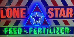 Lone Star Feed Neon Over Painted Metal Sign: Single sided. Approx. 69-1/2" X 36" X 10". Crated measures 73-1/2" x 44-1/2" x 16-3/4. In working condition.