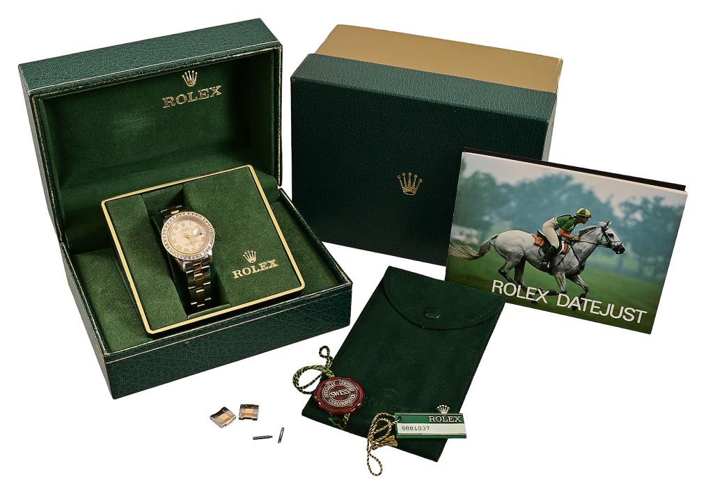 18kt Gold and Stainless Steel Diamond Rolex Watch: *With appraisal. 18kt Yellow Gold and Stainless Steel Diamond Rolex Datejust wrist watch. The watch features a two tone dial with an ivory, pyramid texture, yellow gold roman numeral hour markers, yel