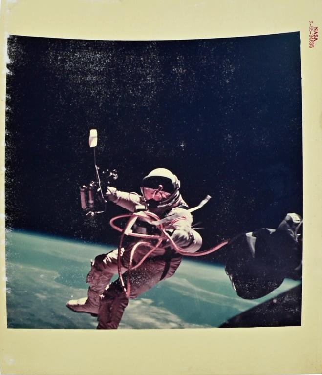 Ed White Gemini 4 First EVA NASA Red Number Photo: NASA red number photo S-65-34635 (3 June 1965) -Astronaut Edward H. White II, pilot on the Gemini-Titan 4 spaceflight, is shown during his egress from the spacecraft. He carries a Hand-Held Self-Maneu