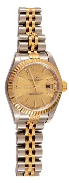 Ladies Oyster Perpetual Datejust Rolex Wrist Watch: With Letter of Appraisal. "One ladies 18kt. yellow and stainless steel oyster perpetual datejust Rolex wrist watch. The watch features a 26.0 mm case with a gold, fluted bezel around a champagne dial.