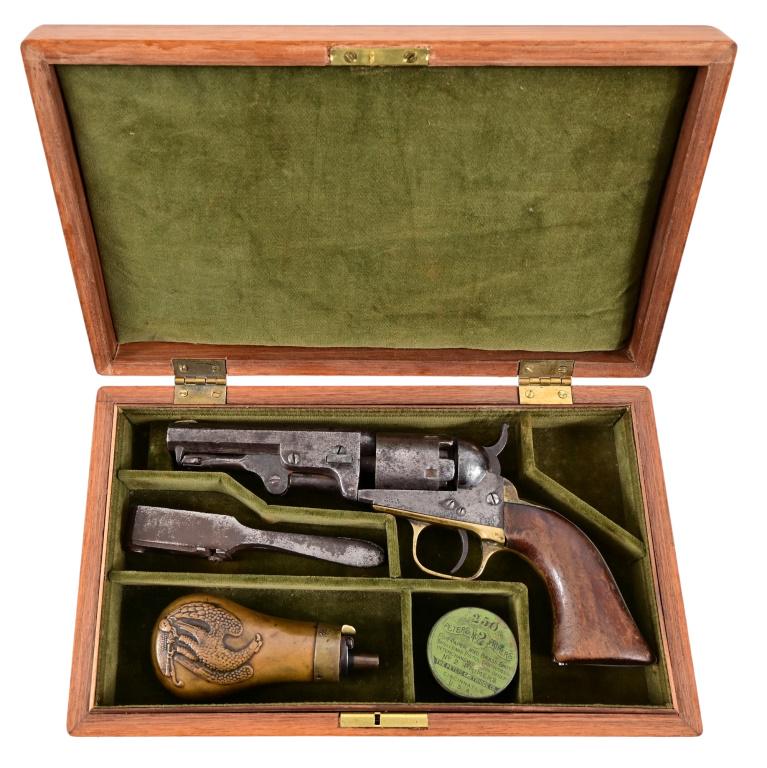 Colt Model 1849 Pocket Revolver Cased: S/N 161933, manufactured 1860. Presentation case with bullet mold, brass Eagle powder flask, and Peters No.2 Primers in original tin. Barrel has New York address, measures 4", walnut grips, has issue