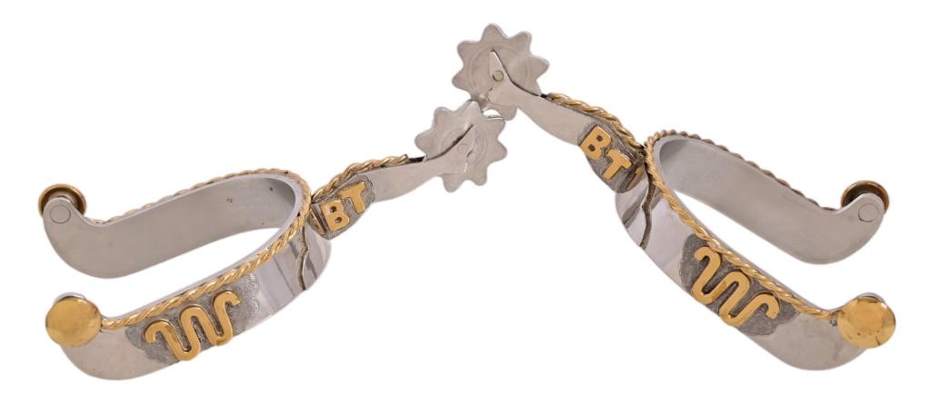 King Ranch Ranch Rodeo Champion Gal-Leg Spurs: These spurs were given to event winners during the annual King Ranch Ranch Rodeo open to King Ranch cowboys (Kinenos) & share holders. This pair was won by Butch Thompson. King Ranch "Running W" brand